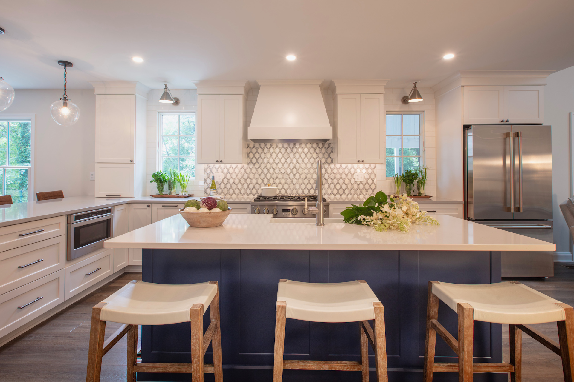 Horizontal image of a large kitchen island with a sink in the middle