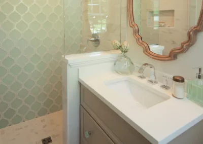 View looking at the shower in a renovated bathroom with a fun tile backsplash