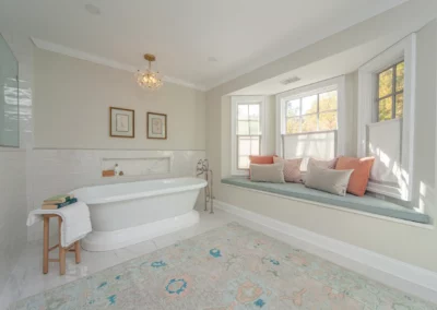 Bathroom renovation view of window seat and stand alone bath tub.