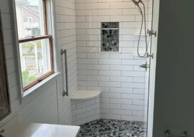 View of a subway tile backsplash inside a renovated bathroom