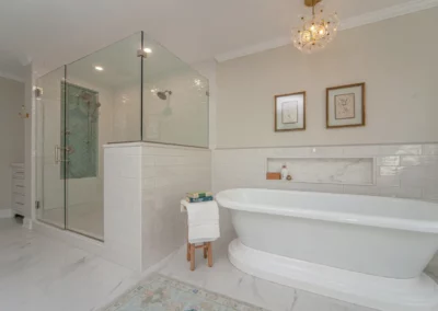 View of a custom renovated bathroom's bathtub and glass shower.