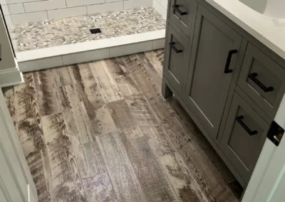 View of tile flooring that resembles wood inside a bathroom