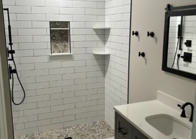 View of a renovated bathroom with a white subway tile inside the shower