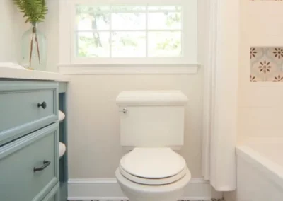 View of toilet and updated window in a bathroom renovation by Oak Ridge Builders