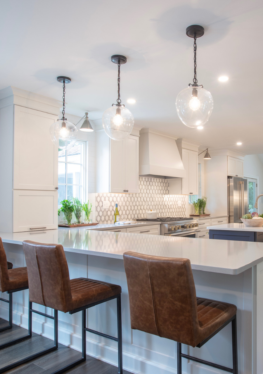 Kitchen Island with Leather Barstools and Clear Pendant Lights