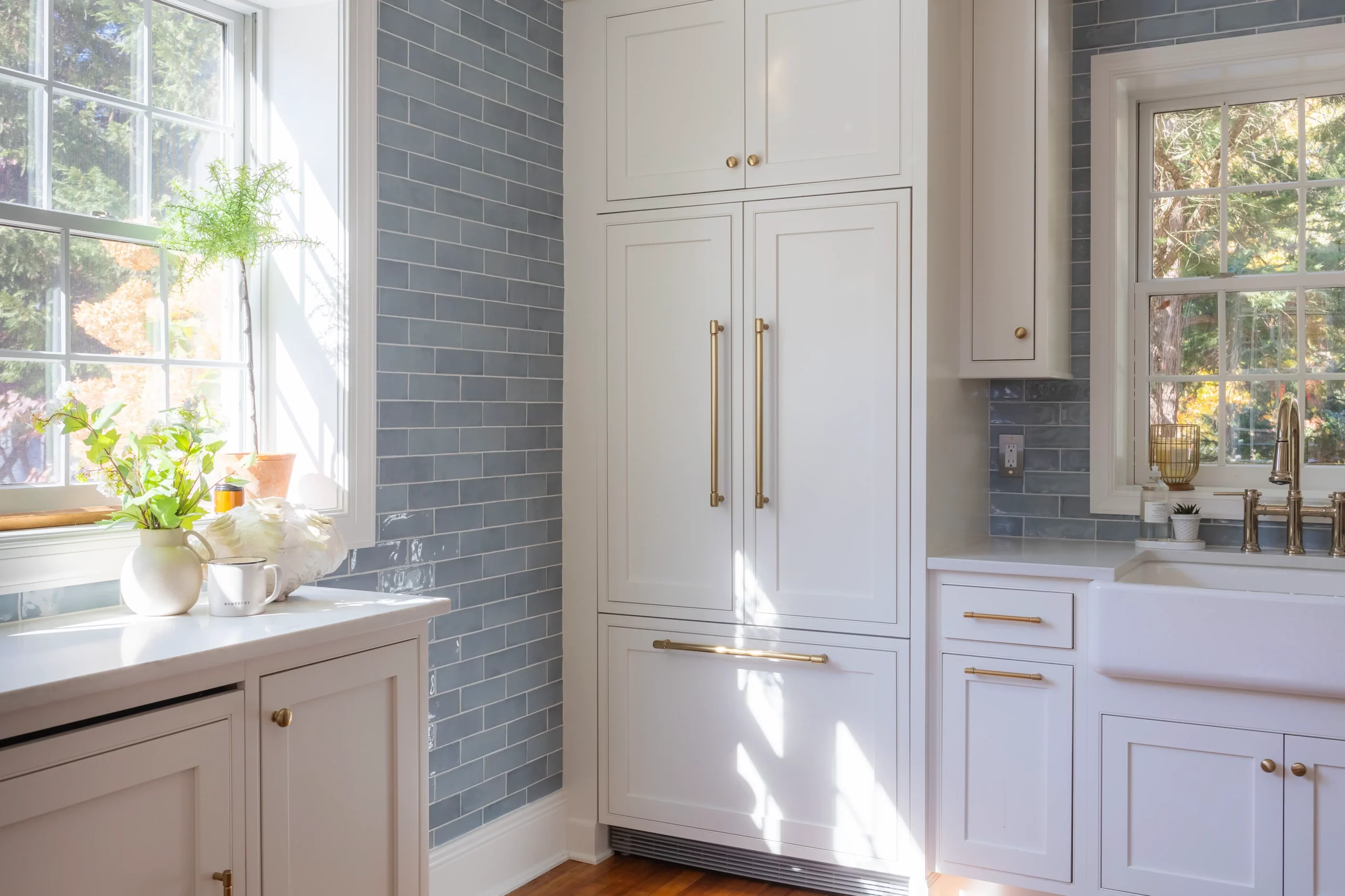 West Haven, Maryland Kitchen Renovation with Ivory Stone Interiors: view of the side window and custom cabinetry beside the left of the sink